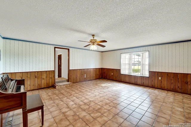 a view of a livingroom with furniture and staircase