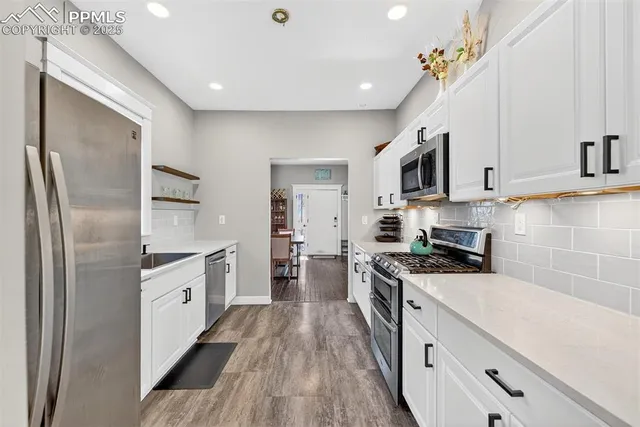 a utility room with cabinets washer and dryer