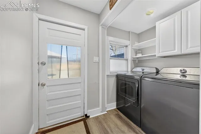 a view of a patio with table and chairs with wooden fence