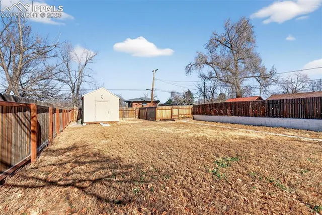 a front view of a house with a yard and covered with snow
