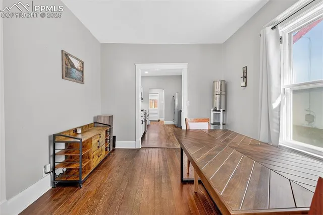 a room with pool table and wooden floor