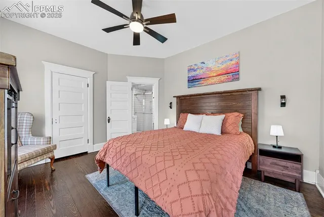 a bedroom with a large bed and a chandelier