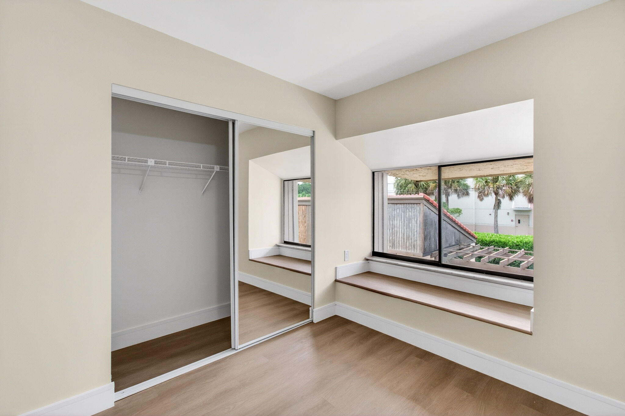 1330 Northwest 13th Street, Unit 12 Boca Raton, FL 33486 - Photo 38 of 52 an empty room with wooden floor and windows