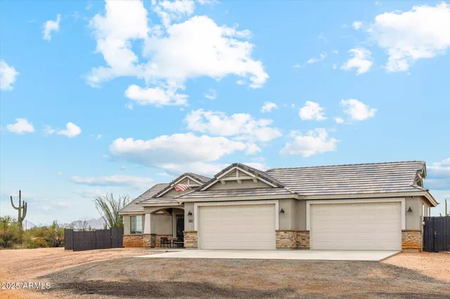 a view of a big house with a big yard and large tree