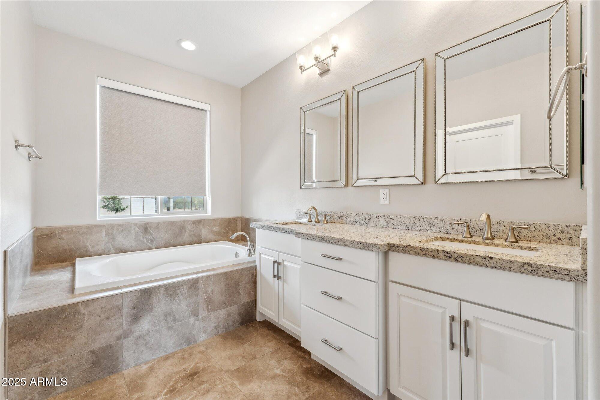 27420 North 170th Street Rio Verde, AZ 85263 - Photo 17 of 39 a bathroom with a granite countertop bathtub a sink and a window