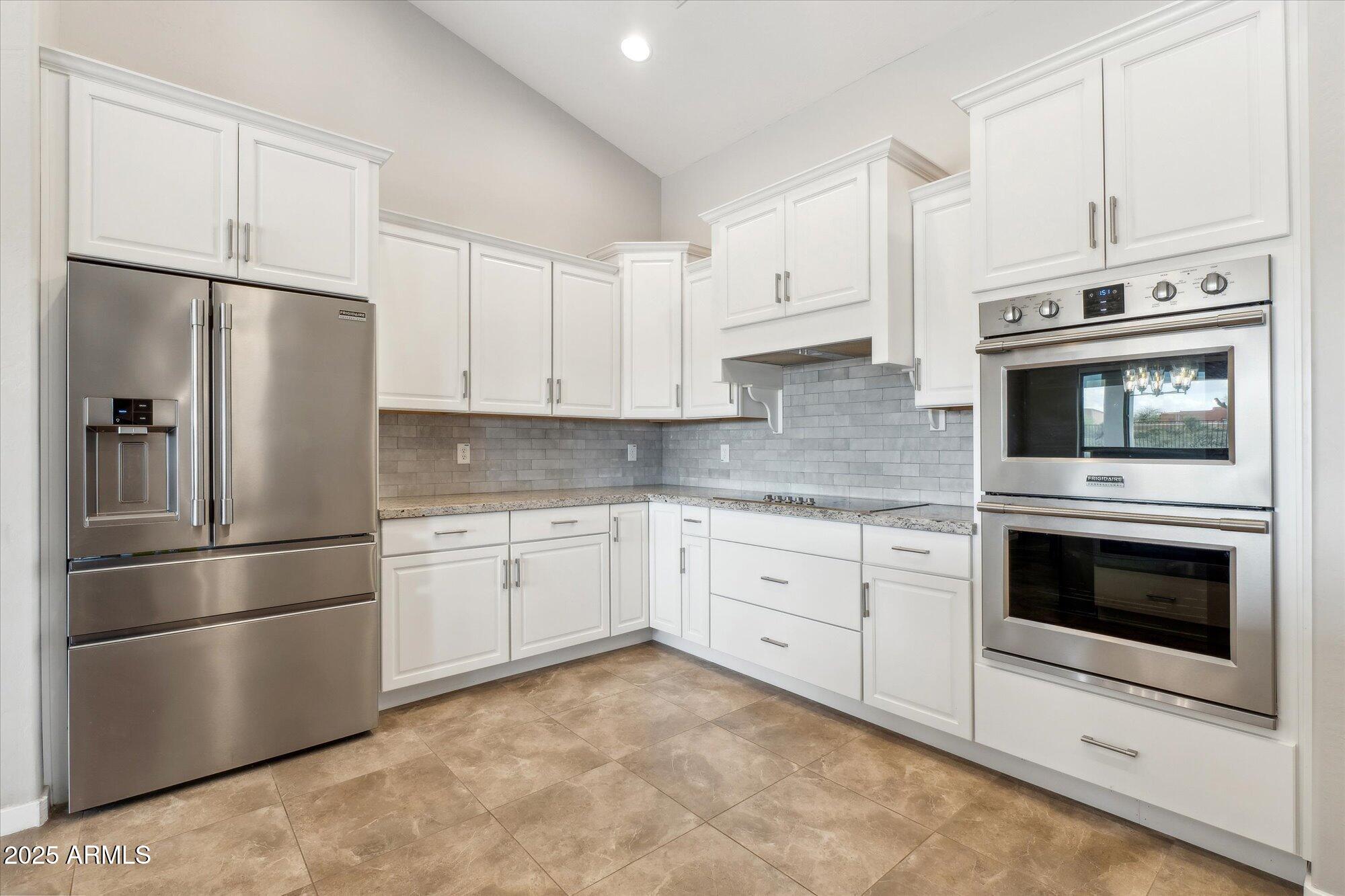 27420 North 170th Street Rio Verde, AZ 85263 - Photo 8 of 39 a kitchen with stainless steel appliances white cabinets white stove a refrigerator and a microwave