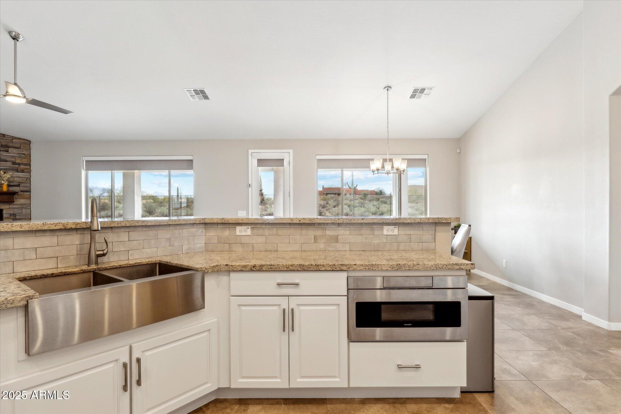 27420 North 170th Street Rio Verde, AZ 85263 - Photo 9 of 39 a kitchen with granite countertop a sink and cabinets