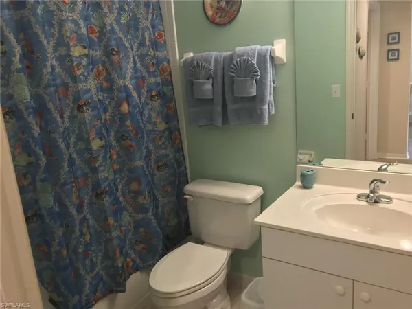 a white toilet sitting next to a bathroom sink
