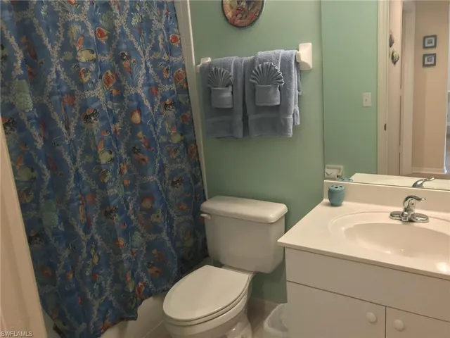 a white toilet sitting next to a bathroom sink