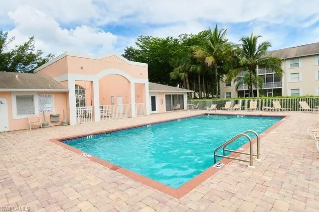 a view of a house with a yard patio and swimming pool