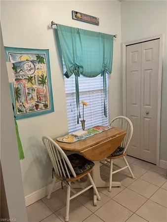 a view of a dining room with furniture and a potted plant