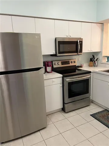 a kitchen with cabinets and steel stainless steel appliances