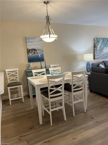 a view of a dining room with furniture wooden floor and chandelier