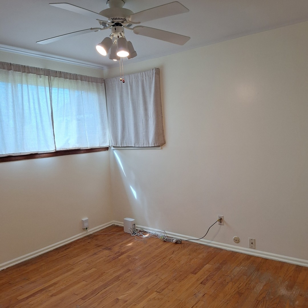 4605 West 84th Place Chicago, IL 60652 - Photo 14 of 30 an empty room with wooden floor and fan