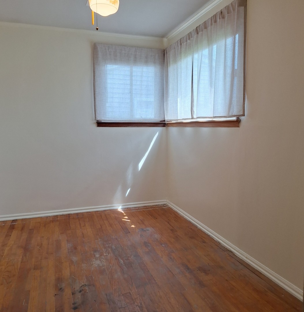 4605 West 84th Place Chicago, IL 60652 - Photo 15 of 30 an empty room with wooden floor and windows
