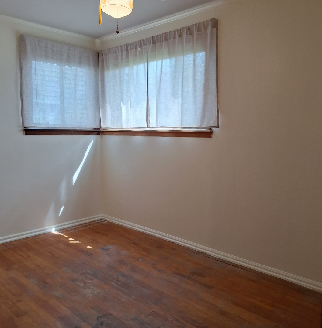 4605 West 84th Place Chicago, IL 60652 - Photo 16 of 30 wooden floor in an empty room with a window
