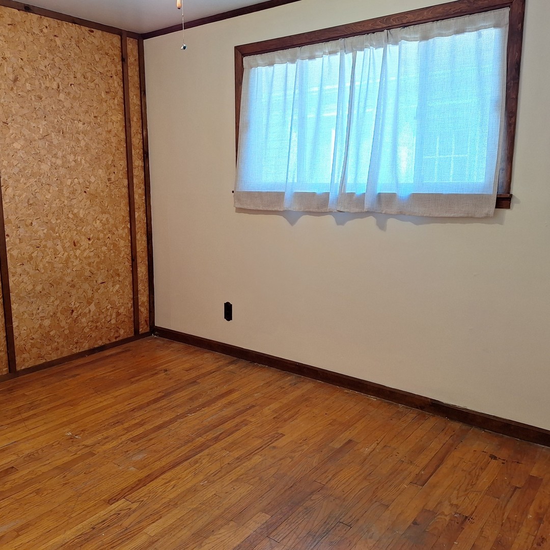 4605 West 84th Place Chicago, IL 60652 - Photo 17 of 30 a view of a room with wooden floor and a window