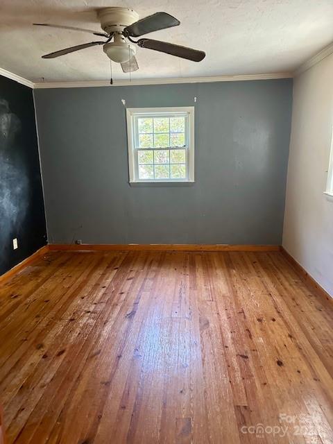 4281 Banoak Road Vale, NC 28168 - Photo 5 of 15 an empty room with wooden floor windows and ceiling fan
