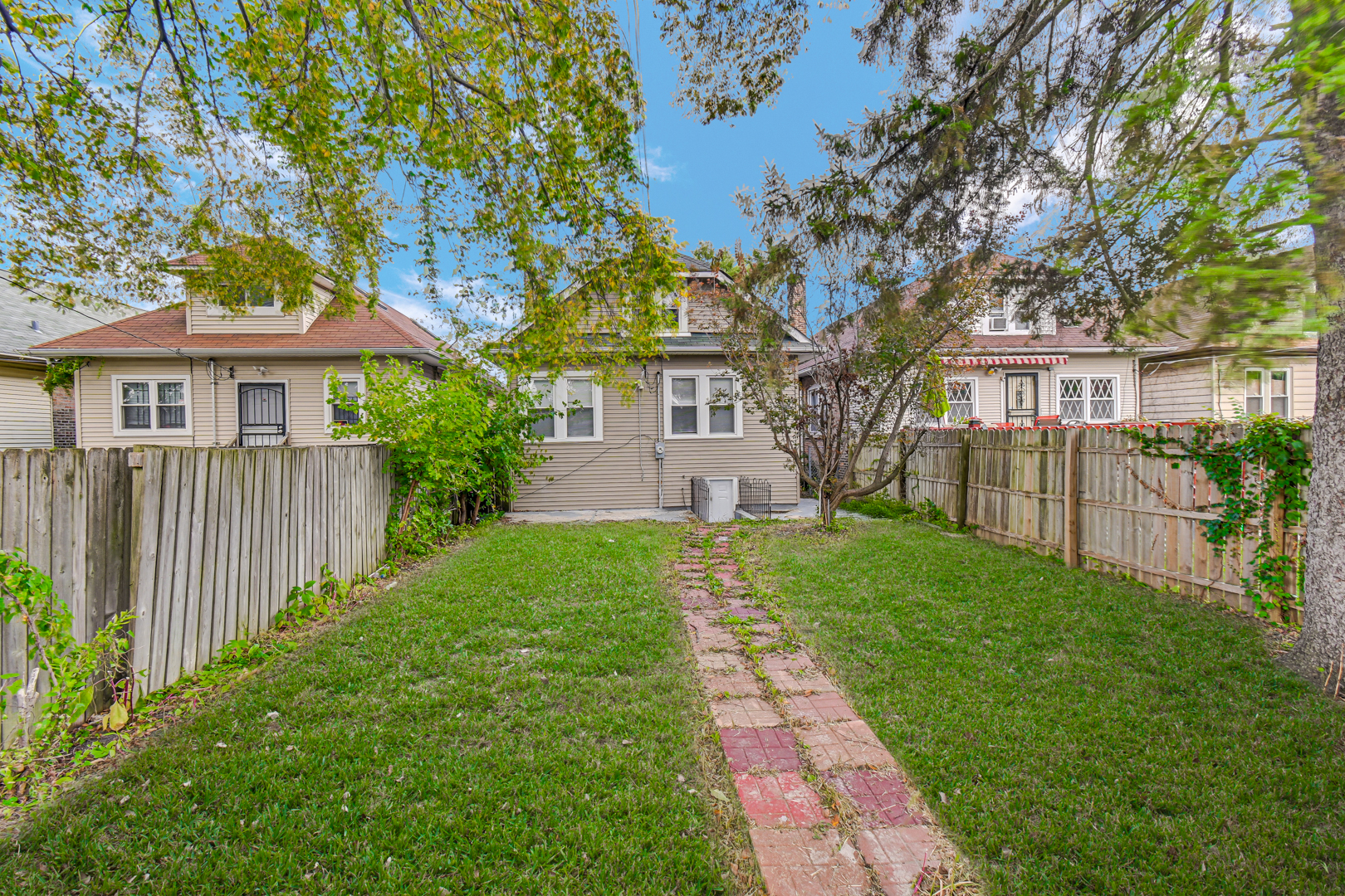 8922 South May Street Chicago, IL 60620 - Photo 23 of 23 a front view of a house with a garden and trees