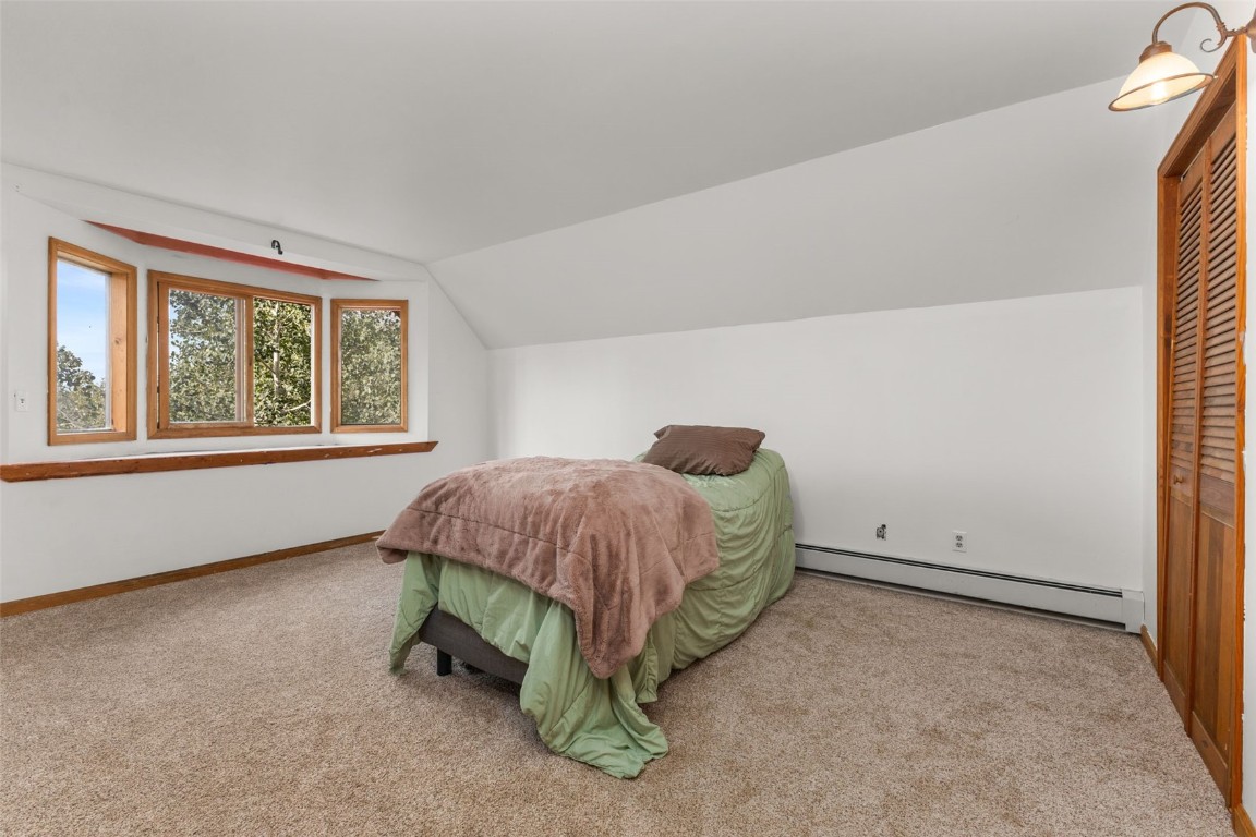 25065 Aspen Way Clark, CO 80428 - Photo 15 of 50 a bed sitting in a room next to a window
