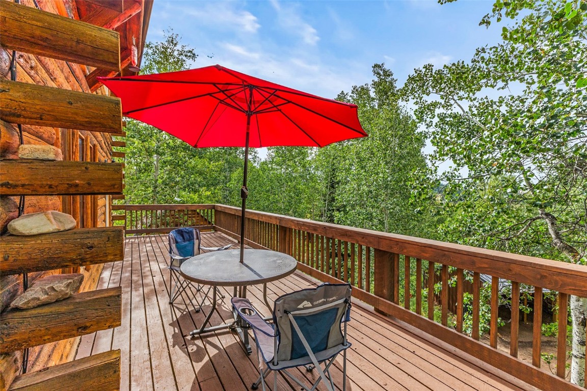 25065 Aspen Way Clark, CO 80428 - Photo 22 of 50 a view of a balcony with chairs and wooden floor
