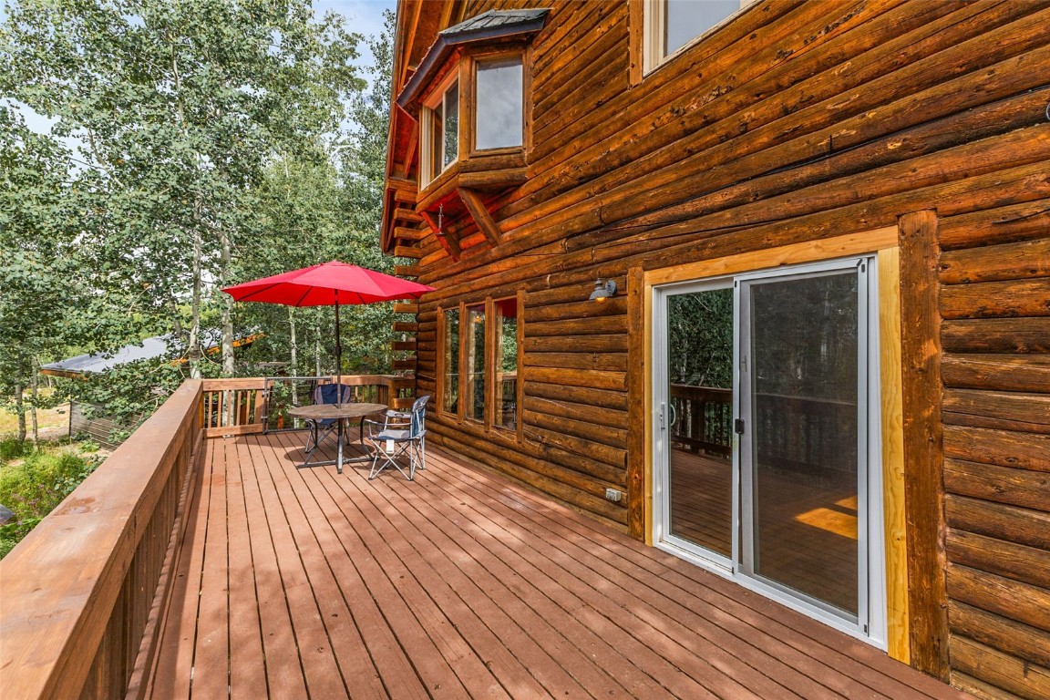 25065 Aspen Way Clark, CO 80428 - Photo 23 of 50 a view of balcony with outdoor seating and wooden floor