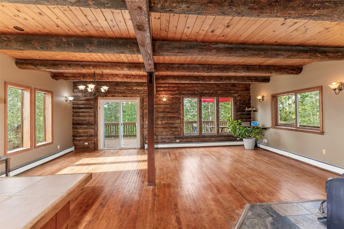 25065 Aspen Way Clark, CO 80428 - Photo 8 of 50 a view of an empty room with wooden floor and a window