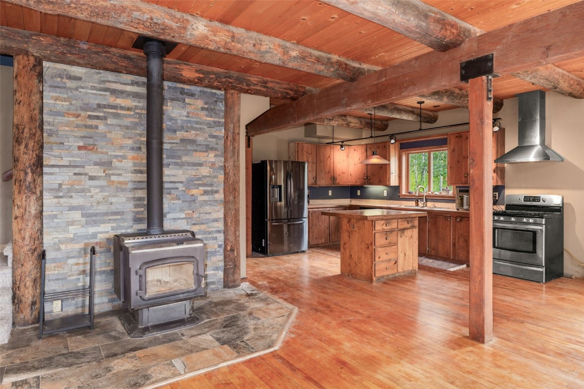 25065 Aspen Way Clark, CO 80428 - Photo 10 of 50 a open kitchen with granite countertop a stove top oven a sink and cabinets