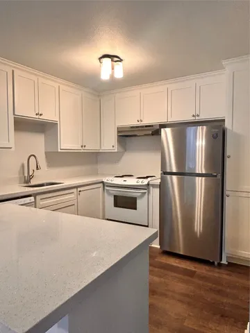 a kitchen with cabinets and stainless steel appliances
