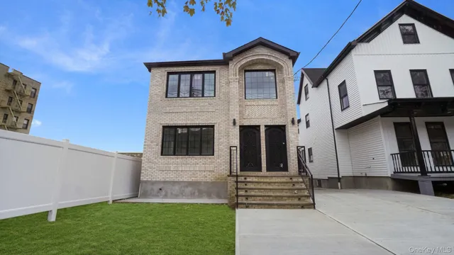 a front view of a house with a garden