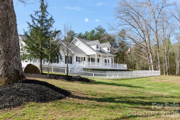 a view of a house with swimming pool and sitting area