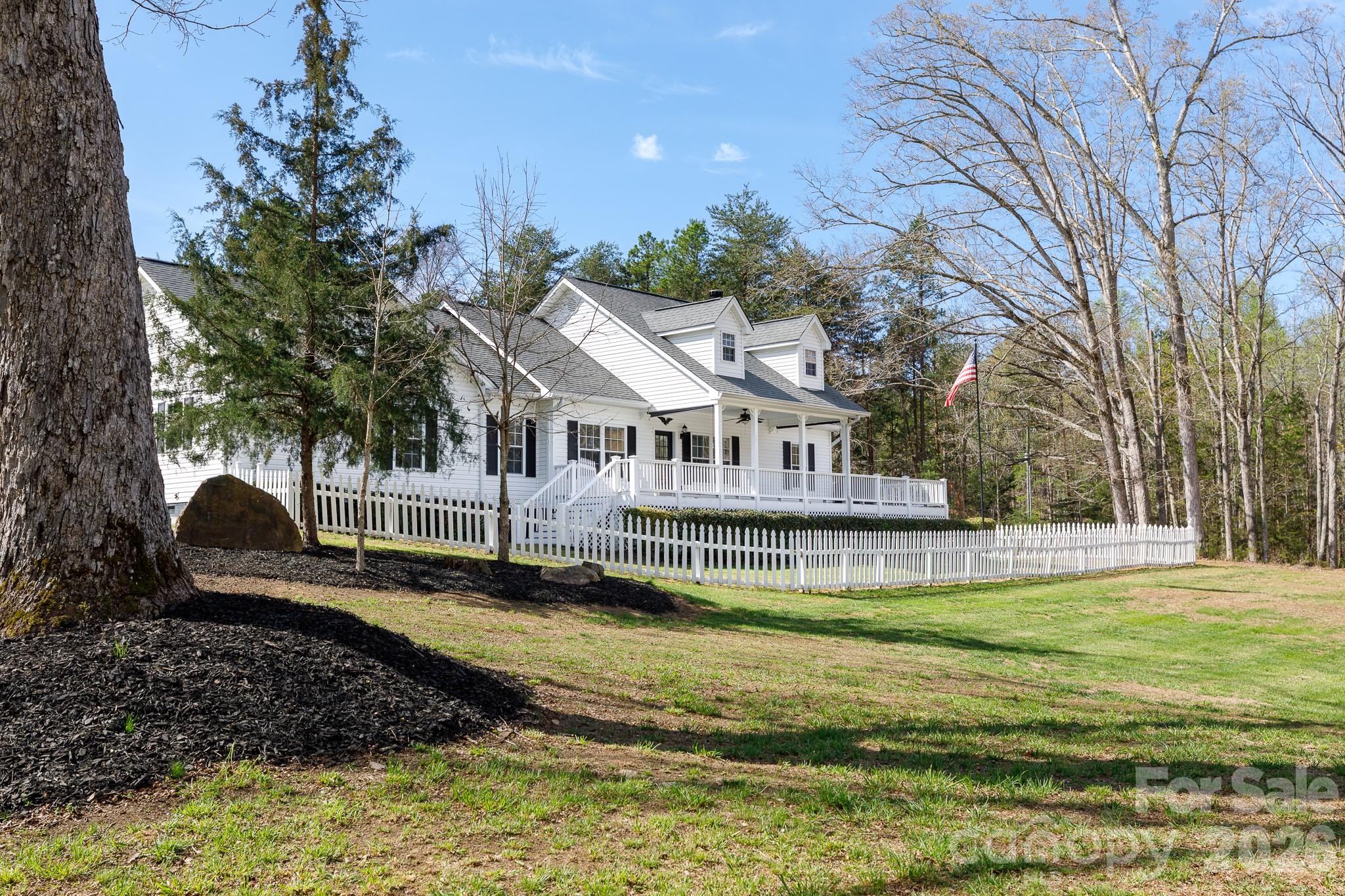 a view of a house with swimming pool and sitting area