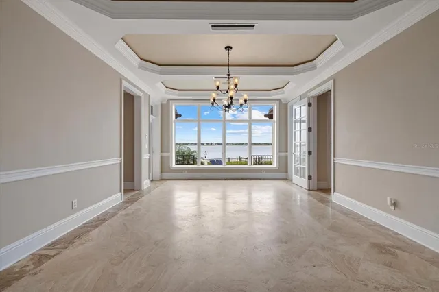 a view of a room with wooden floor and windows