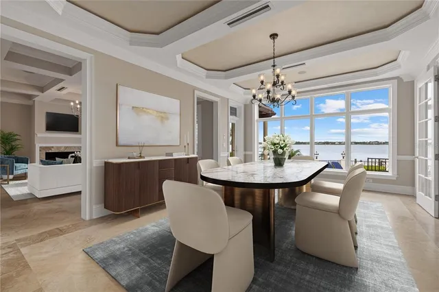 a view of a dining room with furniture and a chandelier