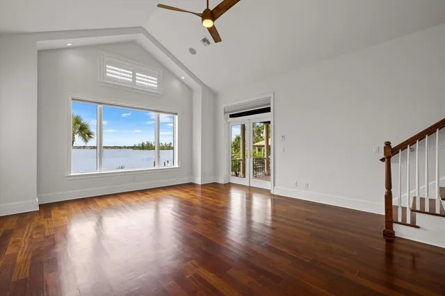 a living room with furniture a wooden floor and a chandelier