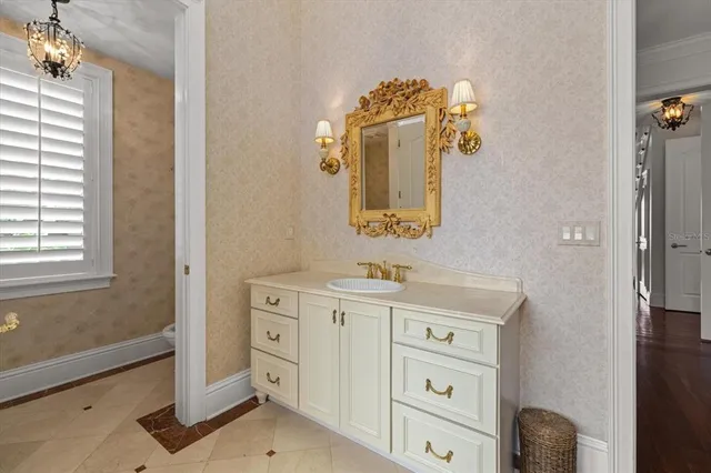 a bathroom with a sink a toilet and a mirror