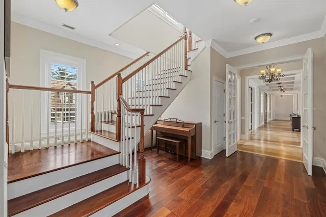 a front view of a house with a yard and potted plants