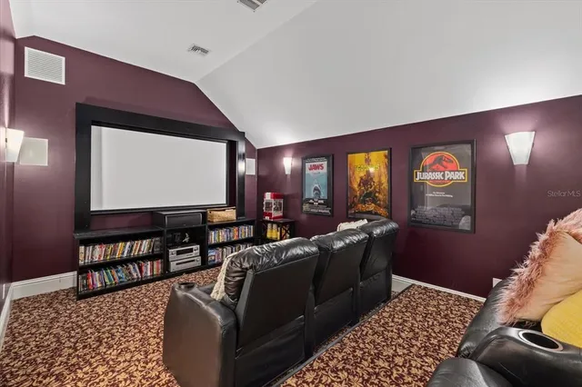 a front view of a house with a yard and potted plants