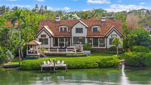 a kitchen with kitchen island a stove a sink and a refrigerator