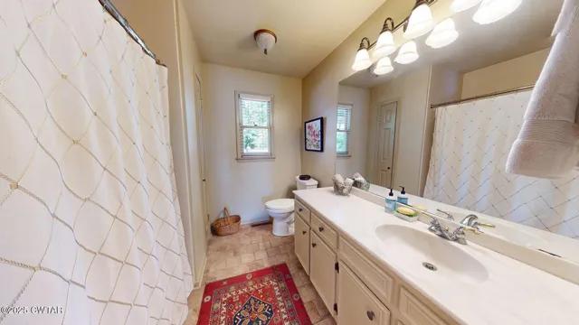 a bathroom with a sink a mirror and a toilet