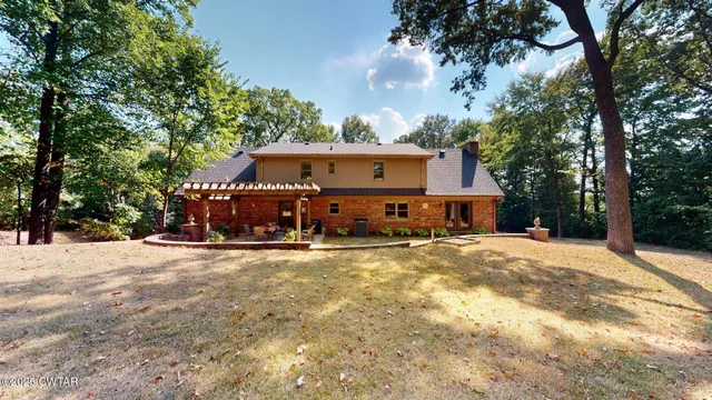 a view of a house with large space and a forest