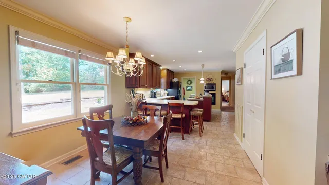 a view of a dining room with furniture and chandelier