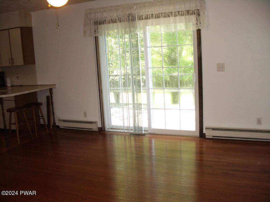 81 Tuthill Road Waymart, PA 18472 - Photo 11 of 29 a view of empty room with wooden floor and fan
