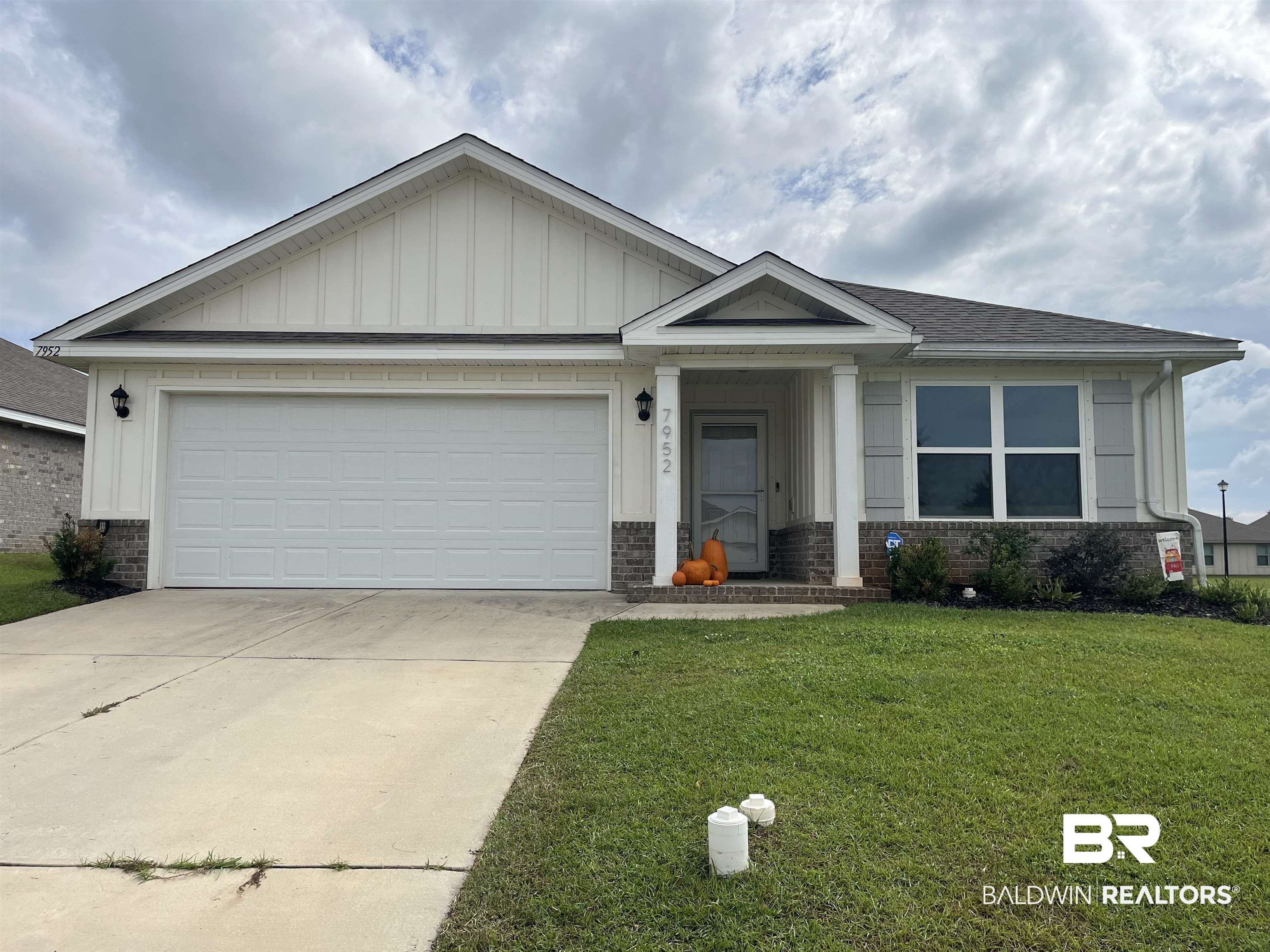 7952 Irwin Loop Daphne, AL 36526 - Photo 1 of 22 View of front of house featuring a garage and a front yard