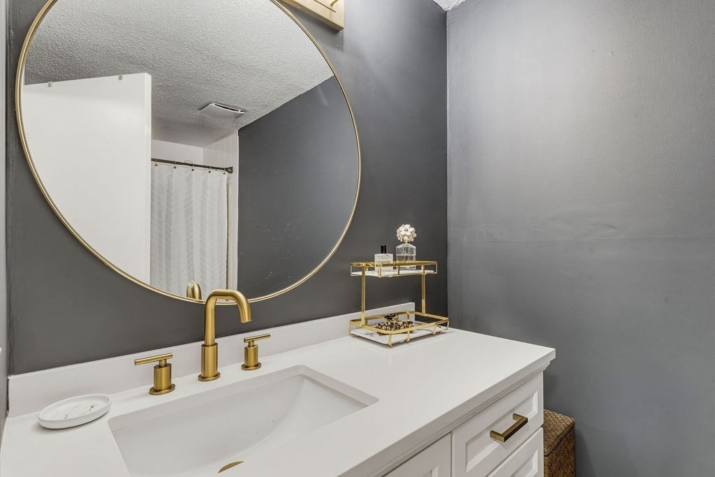 10 Erick Road, Unit 42 Mansfield, MA 02048 - Photo 22 of 33 a bathroom with a sink and a mirror