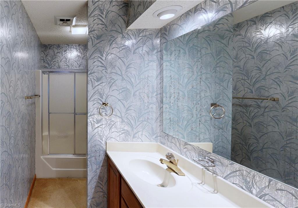 5205 Saddle Brook Road Oak Ridge, NC 27310 - Photo 32 of 50 Upstair's bath has double bowl vanity and separate commode & tub/shower area.