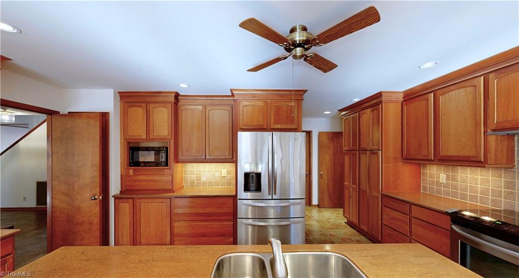 5205 Saddle Brook Road Oak Ridge, NC 27310 - Photo 7 of 50 So much cabinet space and storage. Built in pantry left of stove area.