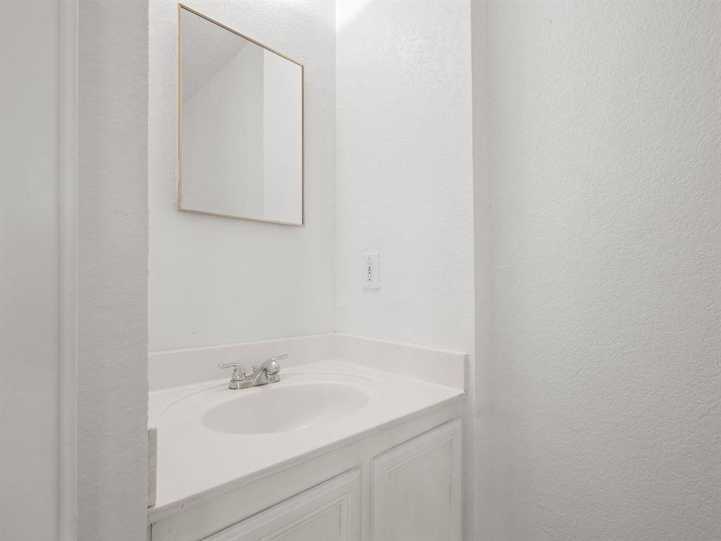 1237 McCary Street Cedar Hill, TX 75104 - Photo 13 of 38 a bathroom with a sink and a mirror