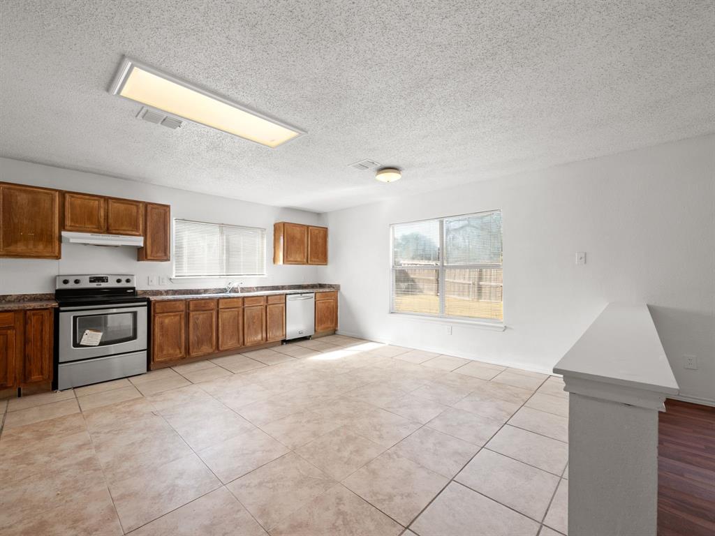 1237 McCary Street Cedar Hill, TX 75104 - Photo 14 of 38 a large kitchen with a stove and a refrigerator