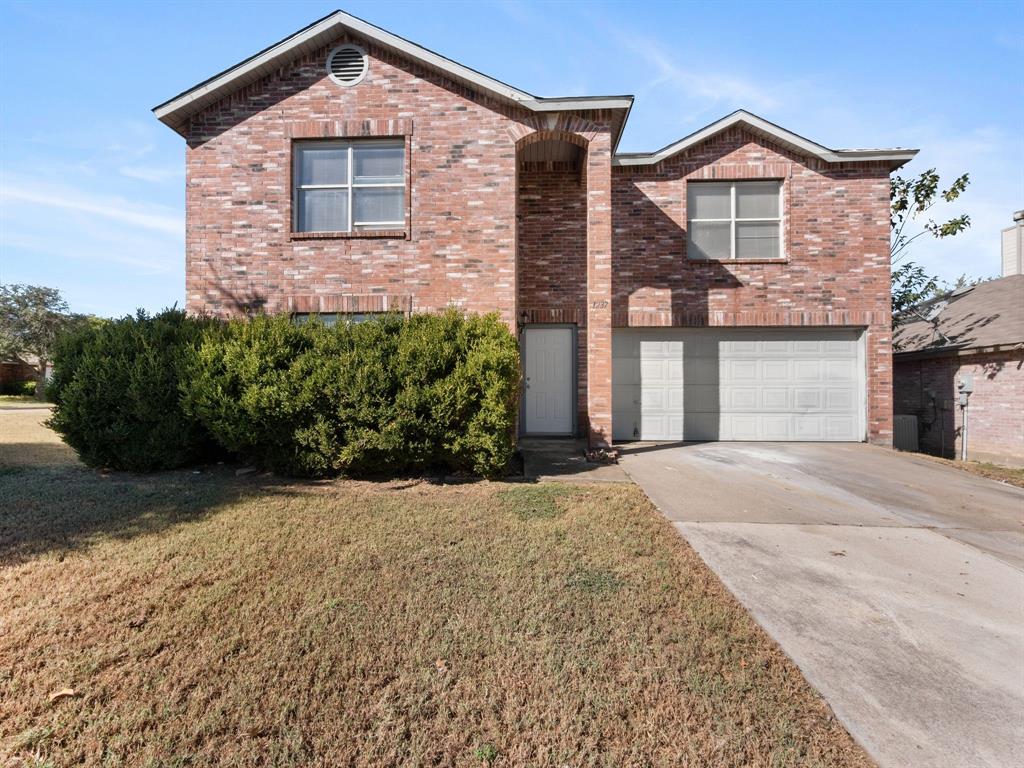 1237 McCary Street Cedar Hill, TX 75104 - Photo 2 of 38 a front view of a house with a yard and garage